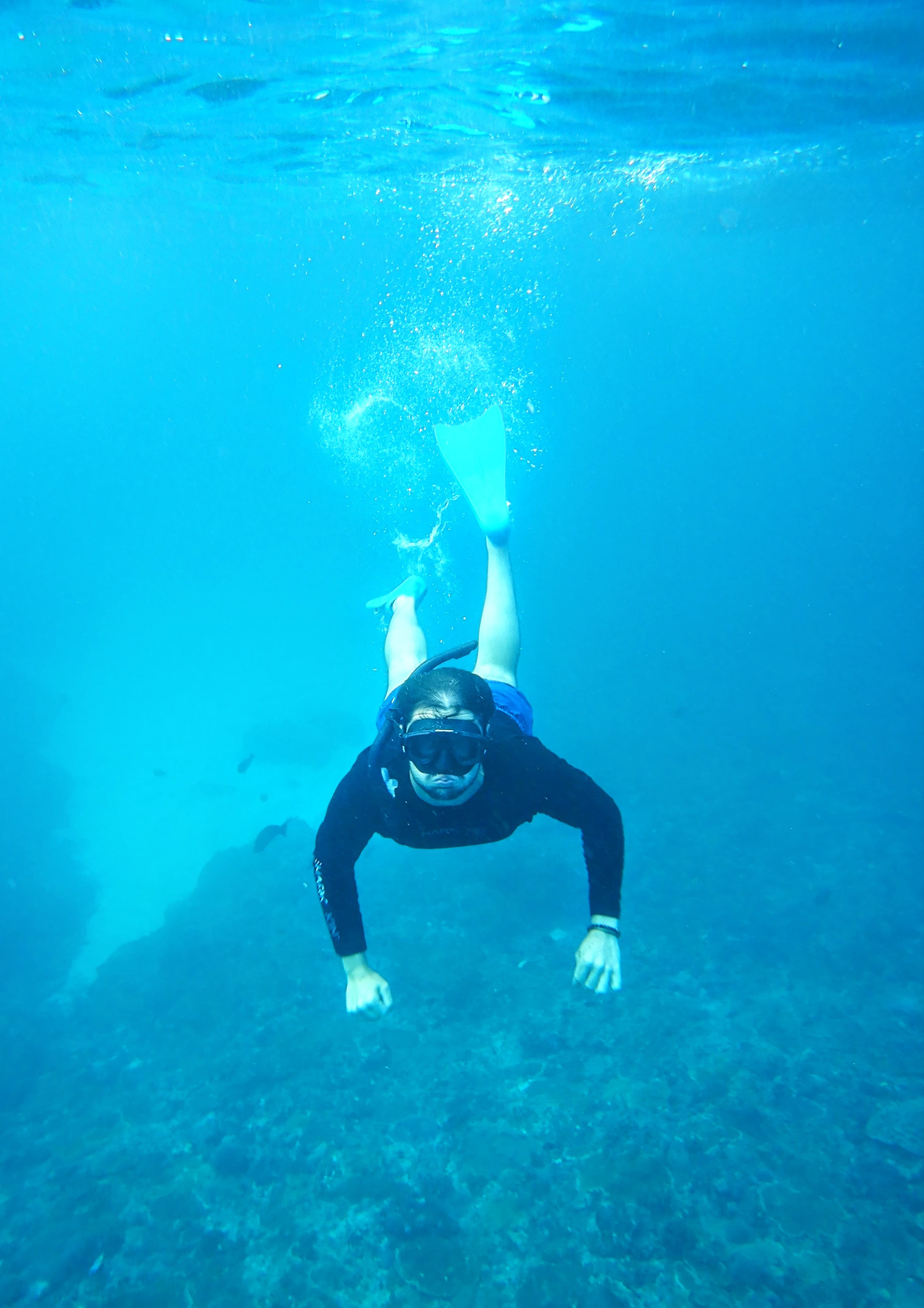 Freediving down toward the reef