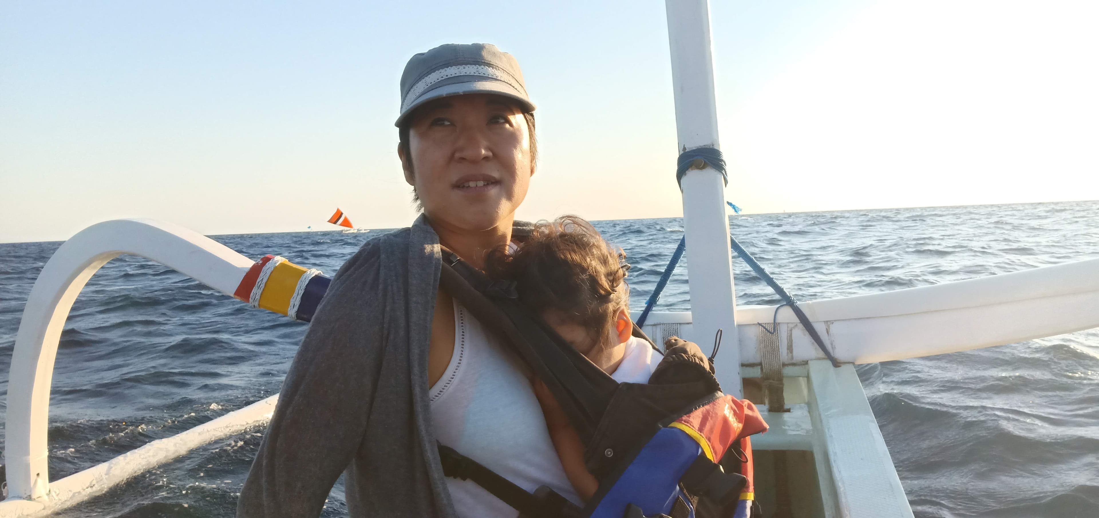 Mother and baby on a boat at golden hour